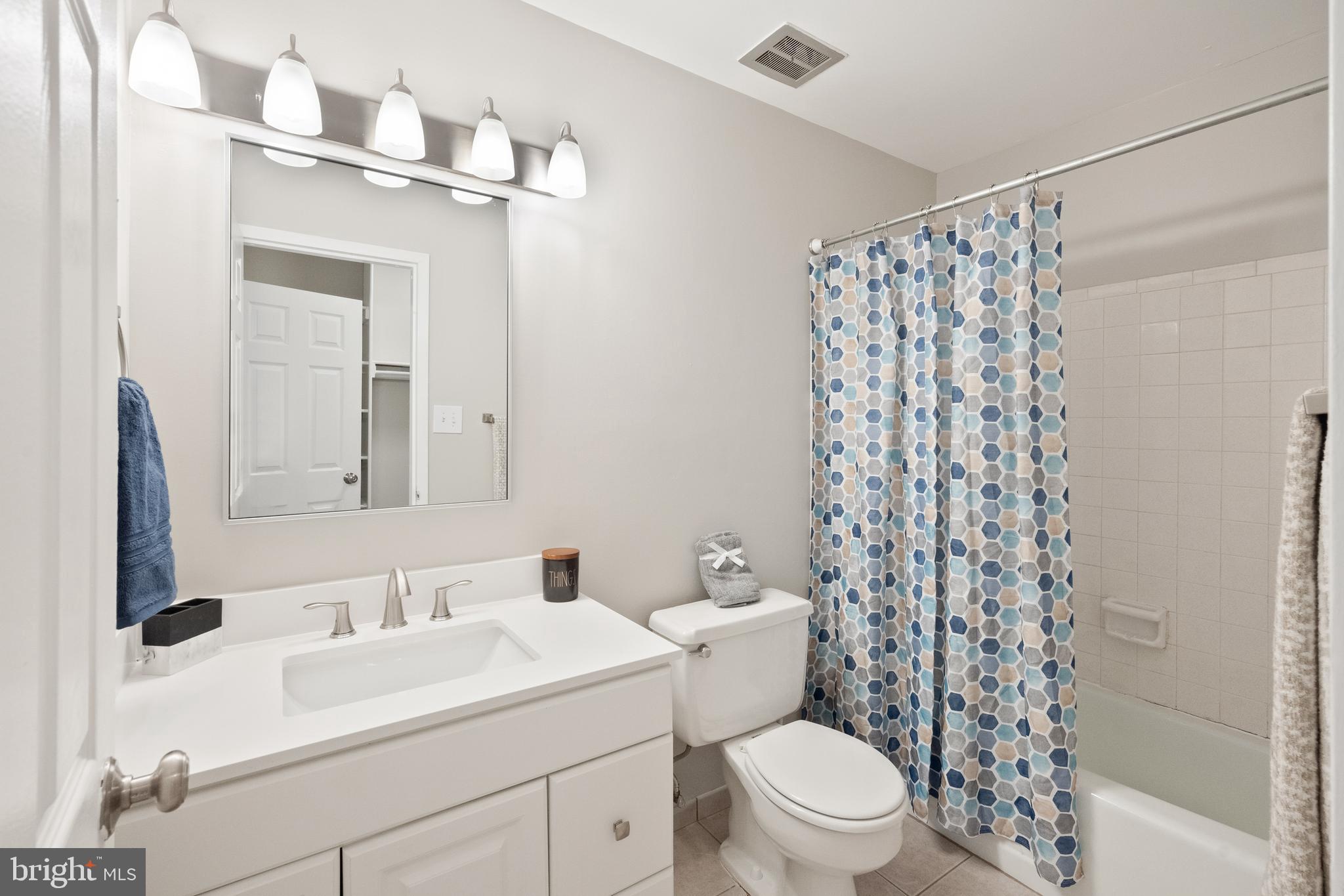 1434 Northgate Square, Unit 34/21B Reston, VA 20190 - Photo 16 of 44 a bathroom with a sink a toilet and shower curtain