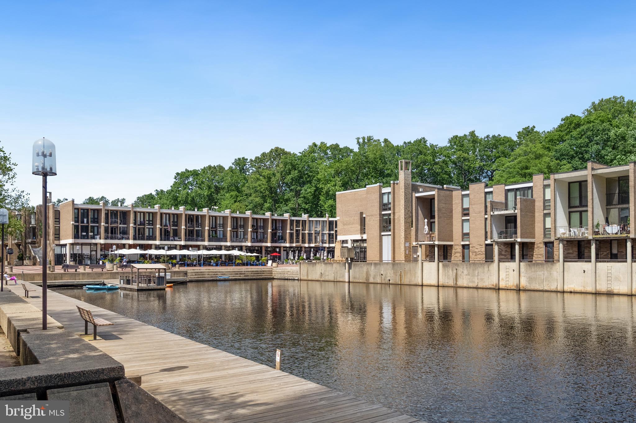 1434 Northgate Square, Unit 34/21B Reston, VA 20190 - Photo 38 of 44 a view of a lake with boats and trees in the background