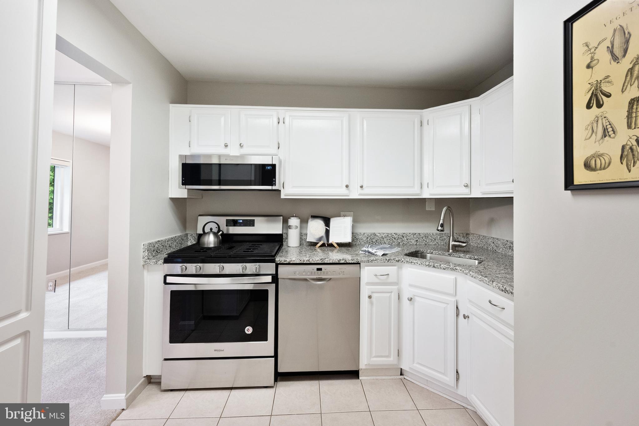 1434 Northgate Square, Unit 34/21B Reston, VA 20190 - Photo 4 of 44 a kitchen with white cabinets and appliances