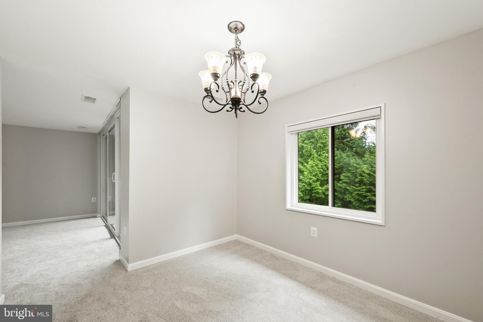 1434 Northgate Square, Unit 34/21B Reston, VA 20190 - Photo 8 of 44 a view of a chandelier fan and window in a room