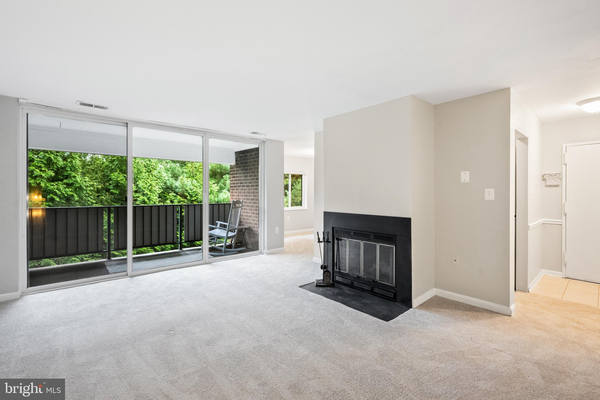 1434 Northgate Square, Unit 34/21B Reston, VA 20190 - Photo 10 of 44 a view of an empty room with a fireplace and a window