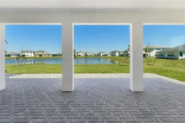 a view of a street with big yard and large trees
