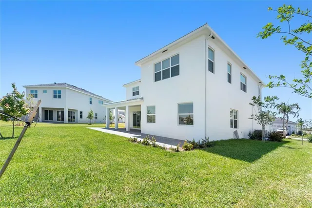 a front view of house with yard and green space