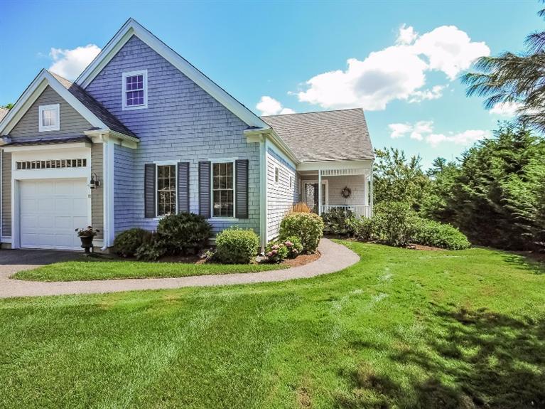 11 Prestwick Road, Unit 78 Bourne, MA 02532 - Photo 3 of 33 a front view of a house with a yard and garage