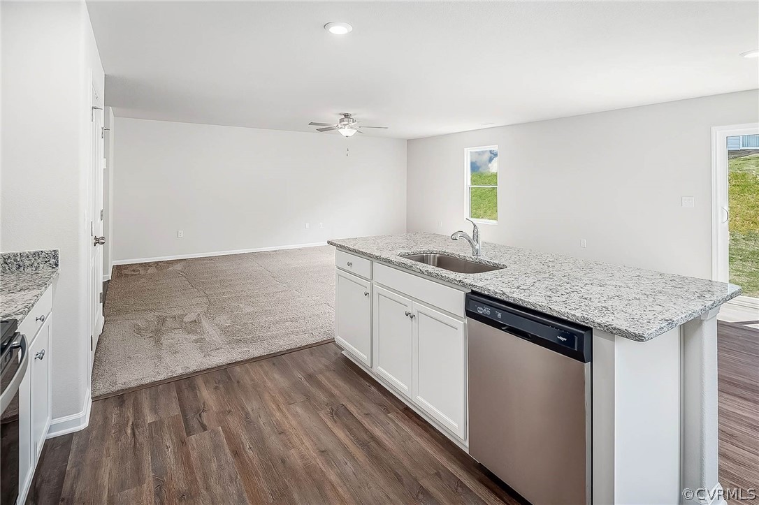 17266 George Ruffin Road Milford, VA 22514 - Photo 5 of 12 a kitchen with granite countertop a sink and a stove top oven