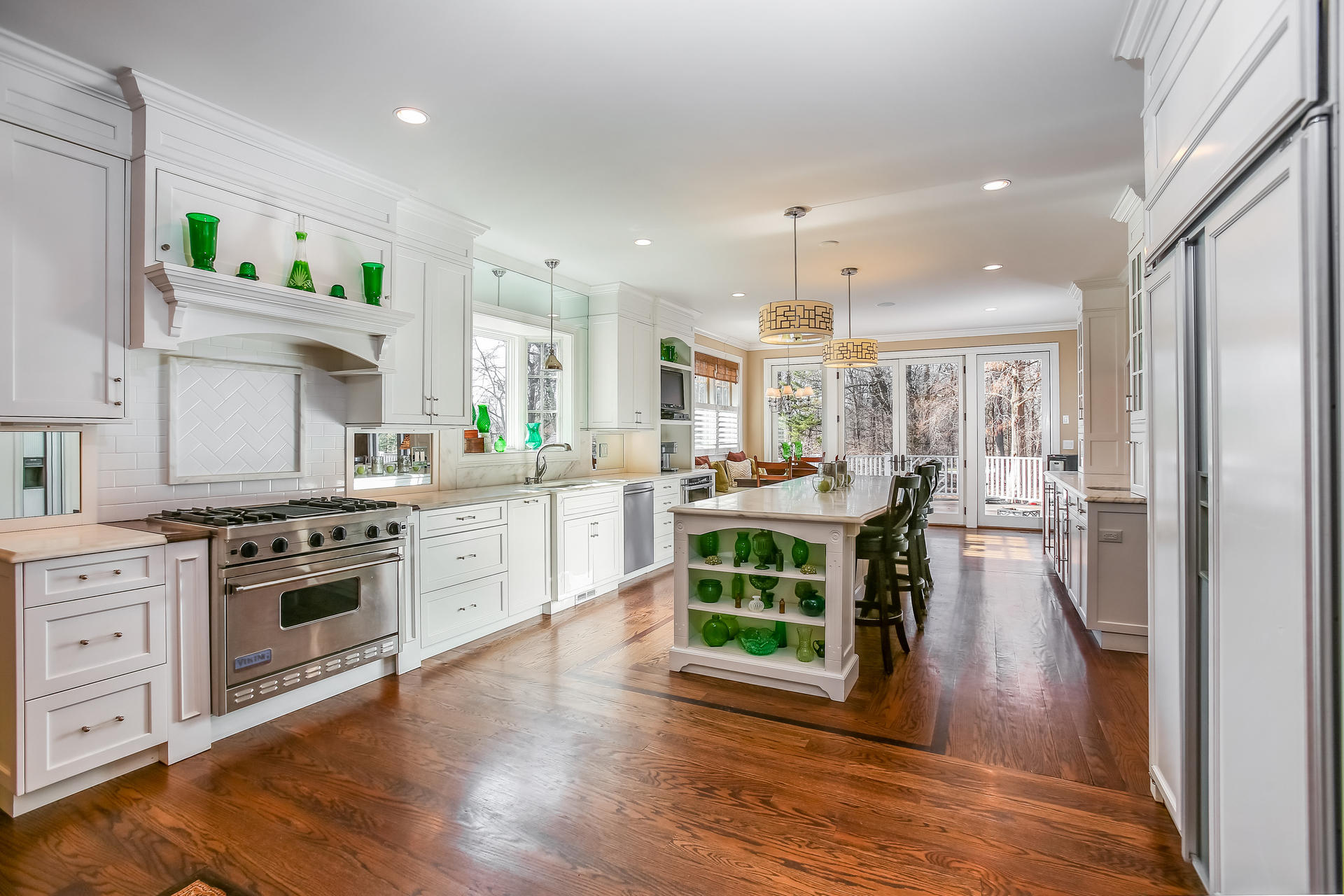 228 Ponus Ridge Road New Canaan, CT 06840 - Photo 13 of 47 a kitchen with stainless steel appliances granite countertop wooden floors and stove