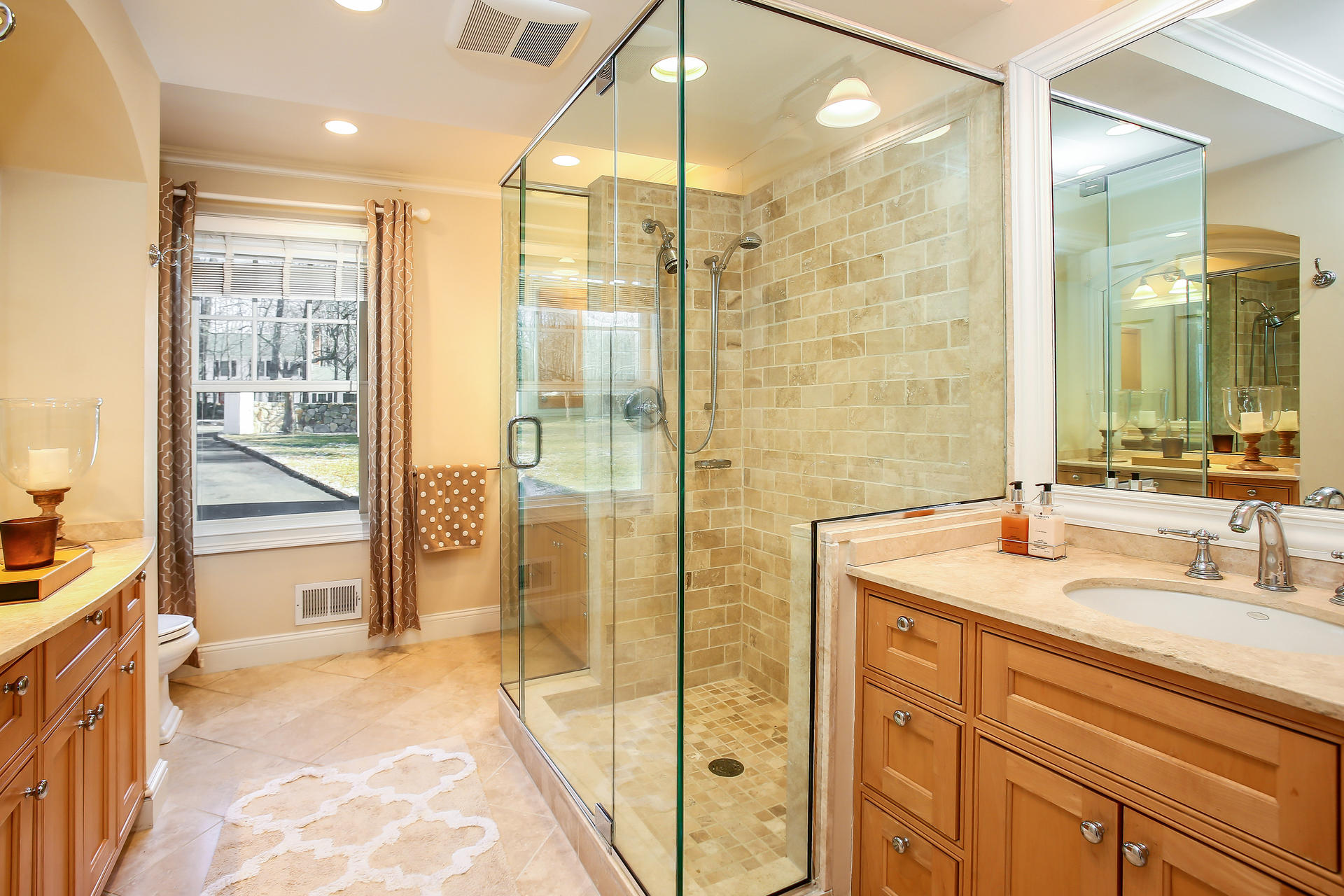 228 Ponus Ridge Road New Canaan, CT 06840 - Photo 17 of 47 a bathroom with a shower sink and mirror