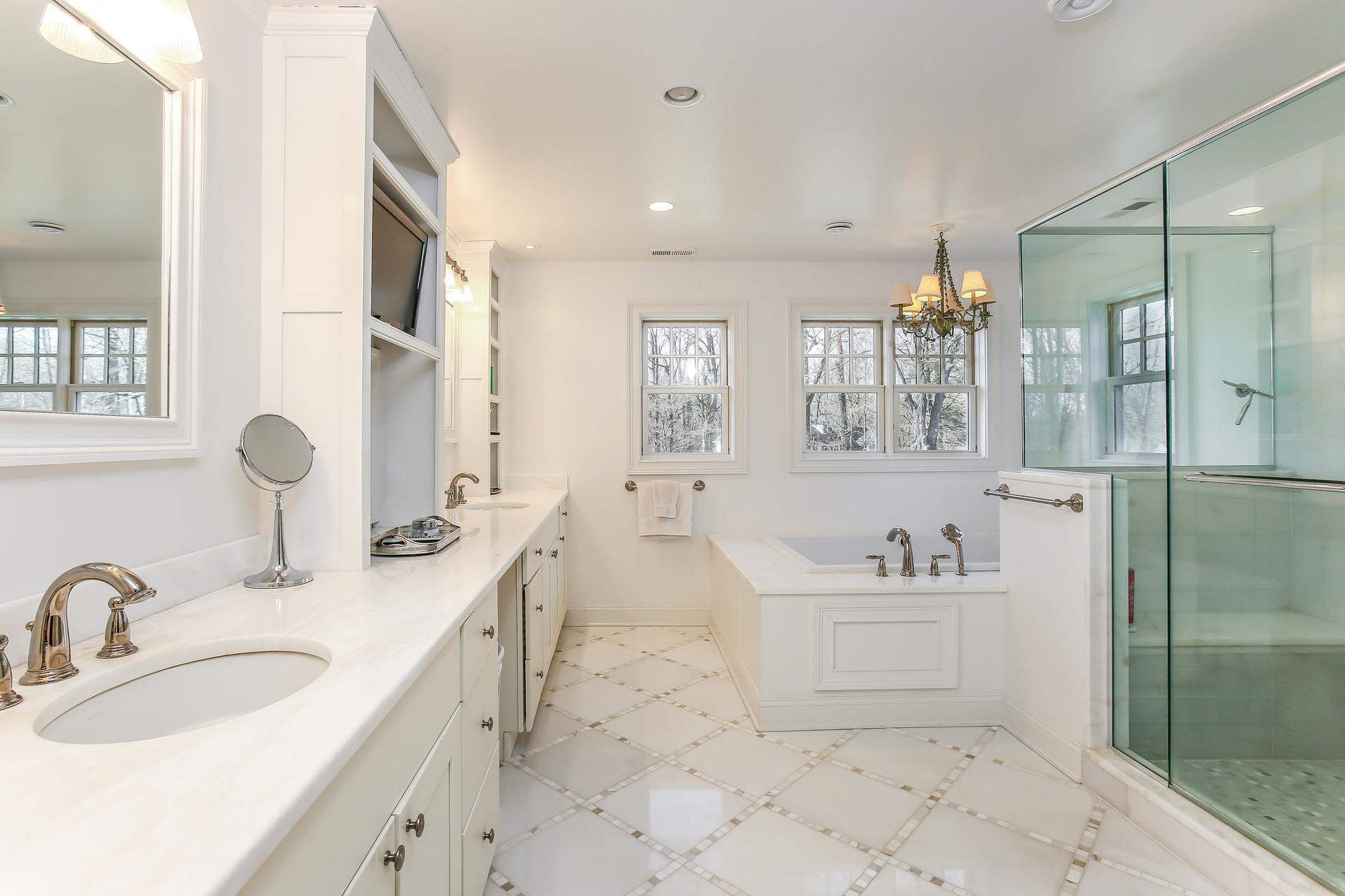 228 Ponus Ridge Road New Canaan, CT 06840 - Photo 21 of 47 a spacious bathroom with a sink a mirror a bathtub and shower