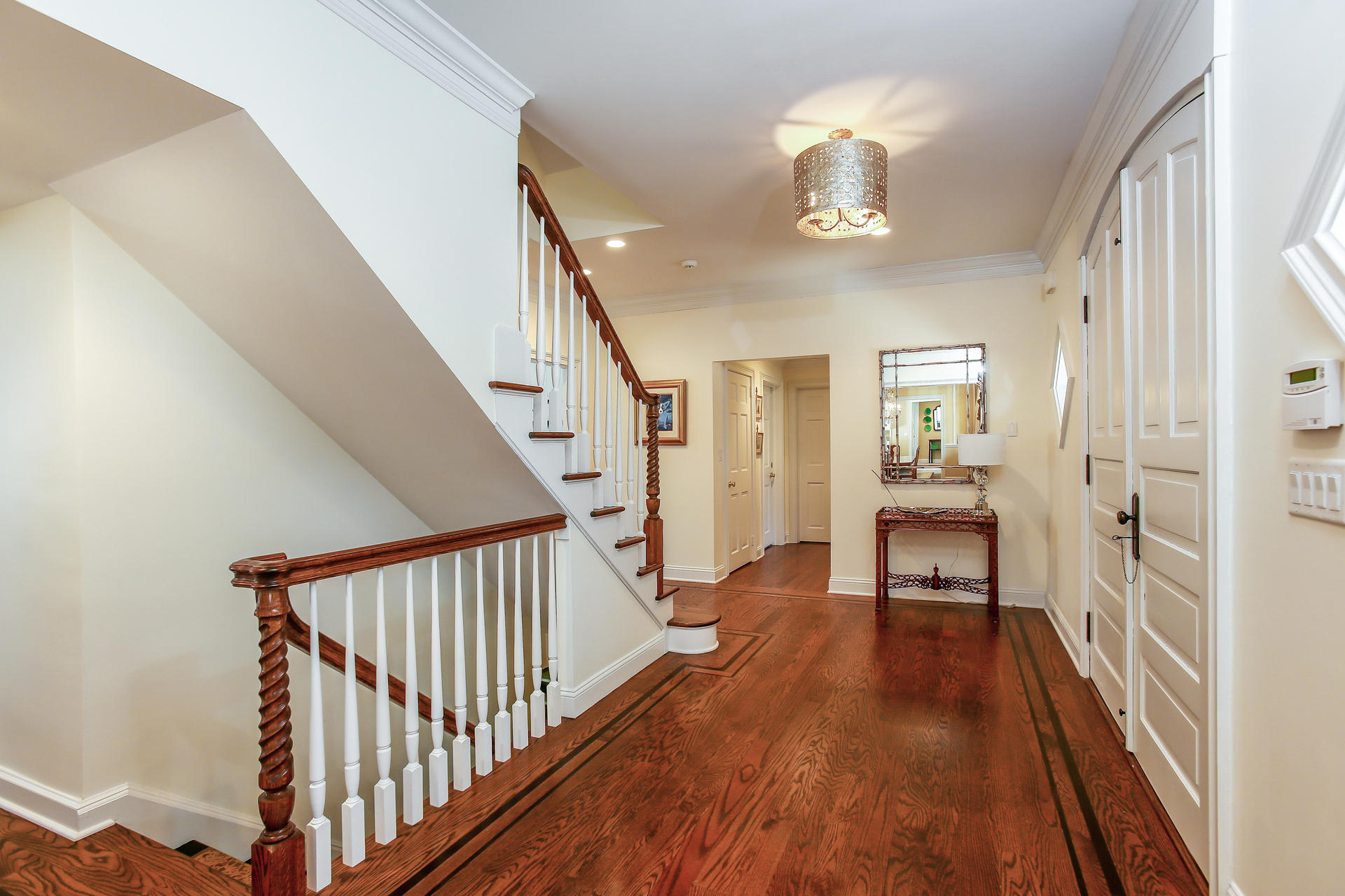 228 Ponus Ridge Road New Canaan, CT 06840 - Photo 26 of 47 a view of a hallway with wooden floor and staircase