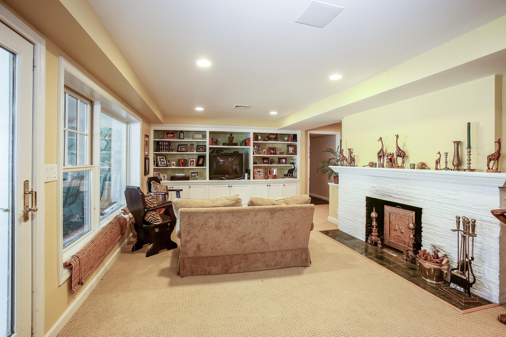 228 Ponus Ridge Road New Canaan, CT 06840 - Photo 27 of 47 a living room with furniture and a fireplace