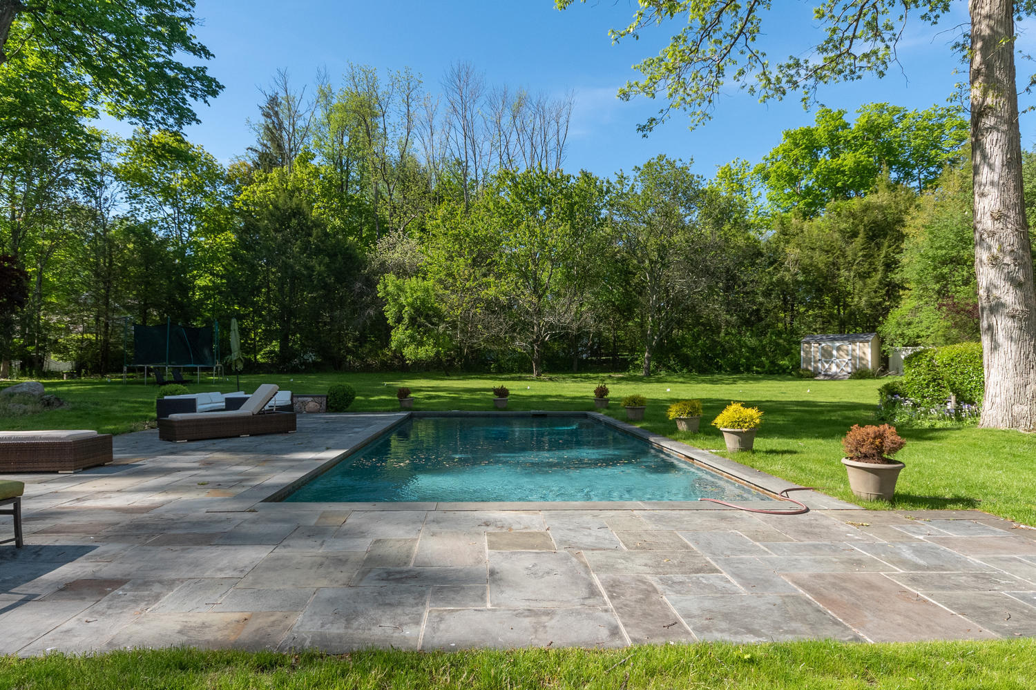 228 Ponus Ridge Road New Canaan, CT 06840 - Photo 3 of 47 a view of backyard with swimming pool and outdoor seating