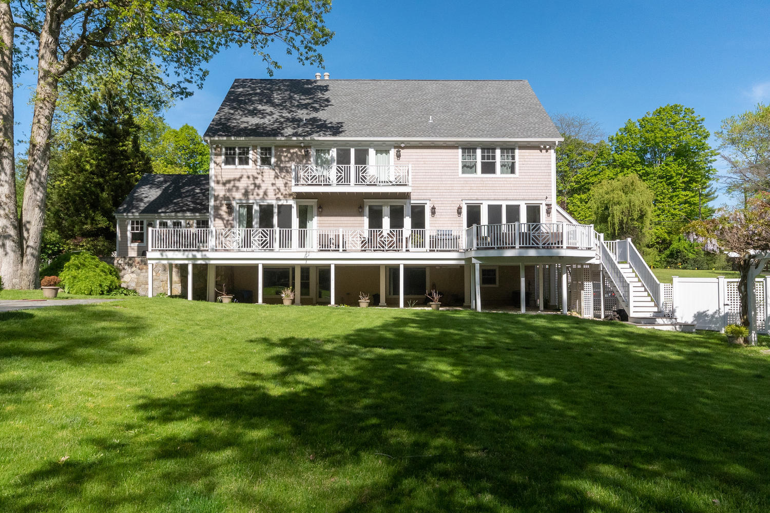 228 Ponus Ridge Road New Canaan, CT 06840 - Photo 39 of 47 a front view of a house with a garden