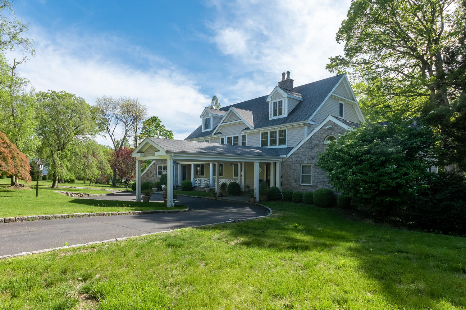 228 Ponus Ridge Road New Canaan, CT 06840 - Photo 4 of 47 a front view of house with yard and green space