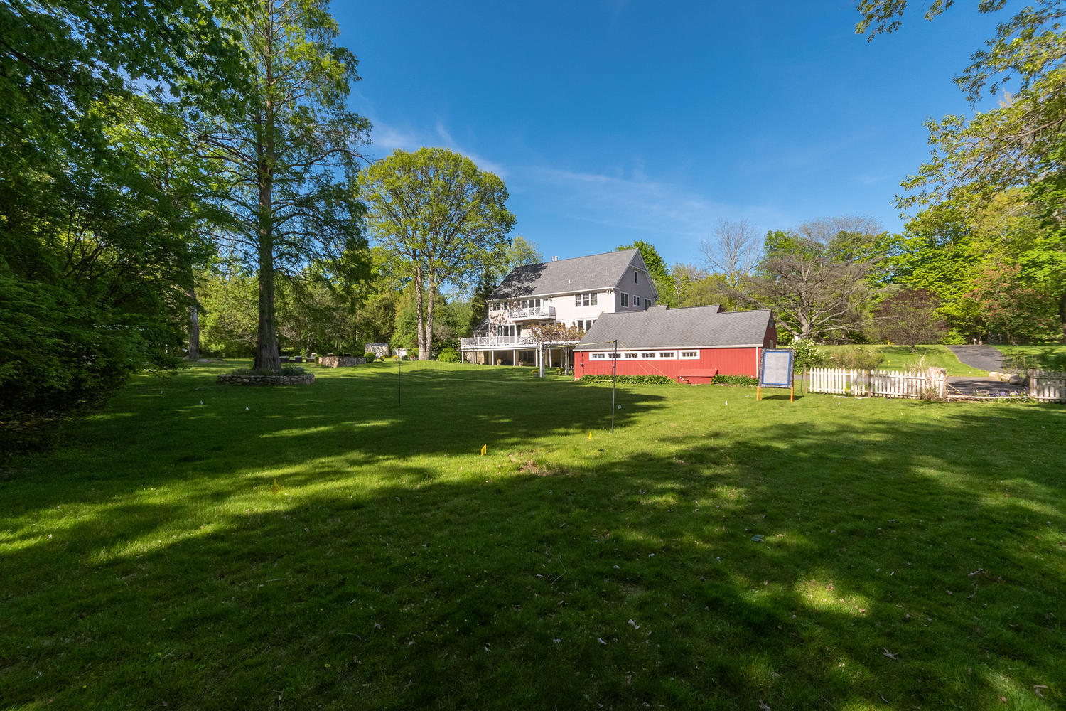 228 Ponus Ridge Road New Canaan, CT 06840 - Photo 42 of 47 a front view of a house with a garden