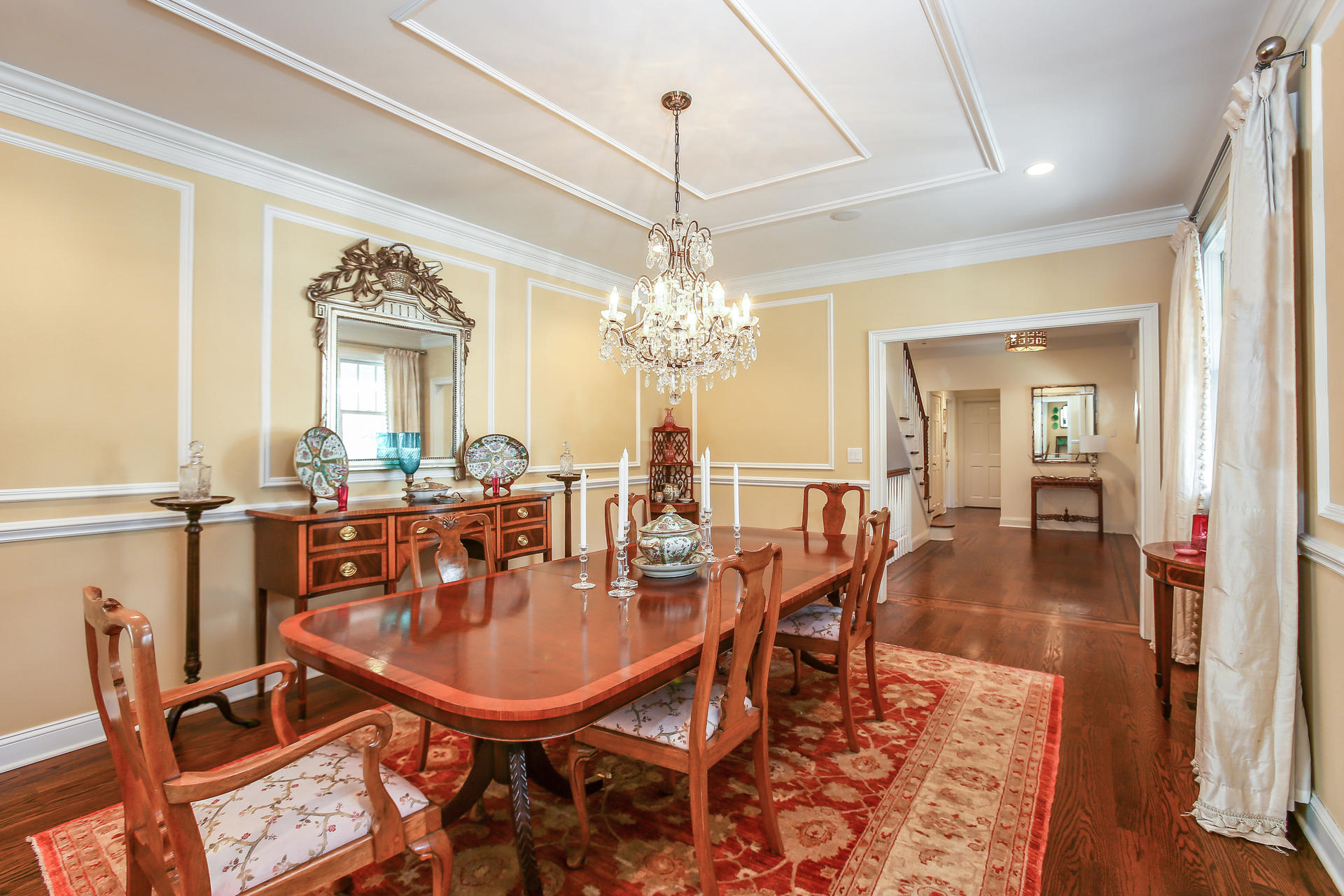 228 Ponus Ridge Road New Canaan, CT 06840 - Photo 9 of 47 a dining room with furniture a chandelier and wooden floor
