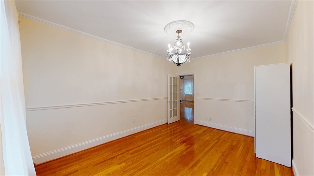 311 Tappan Street, Unit 3 Brookline, MA 02445 - Photo 23 of 35 a view of empty room with wooden floor