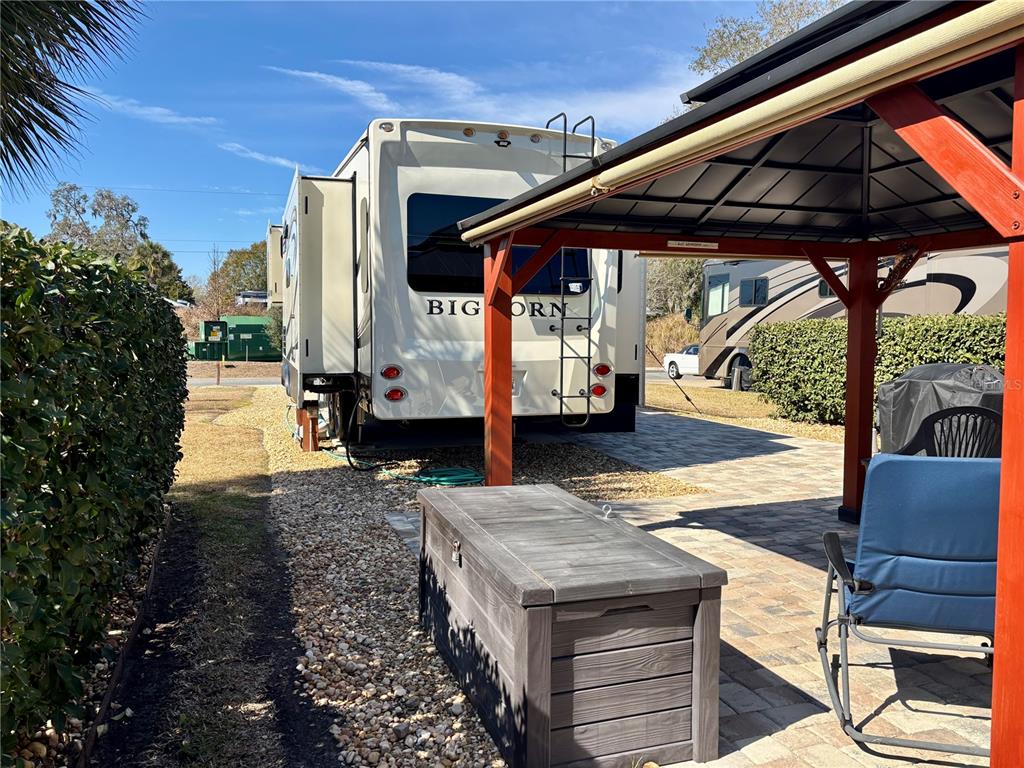 3047 Northeast 102nd Ave Road Silver Springs, FL 34488 - Photo 14 of 87 a view of a patio with table and chairs under an umbrella
