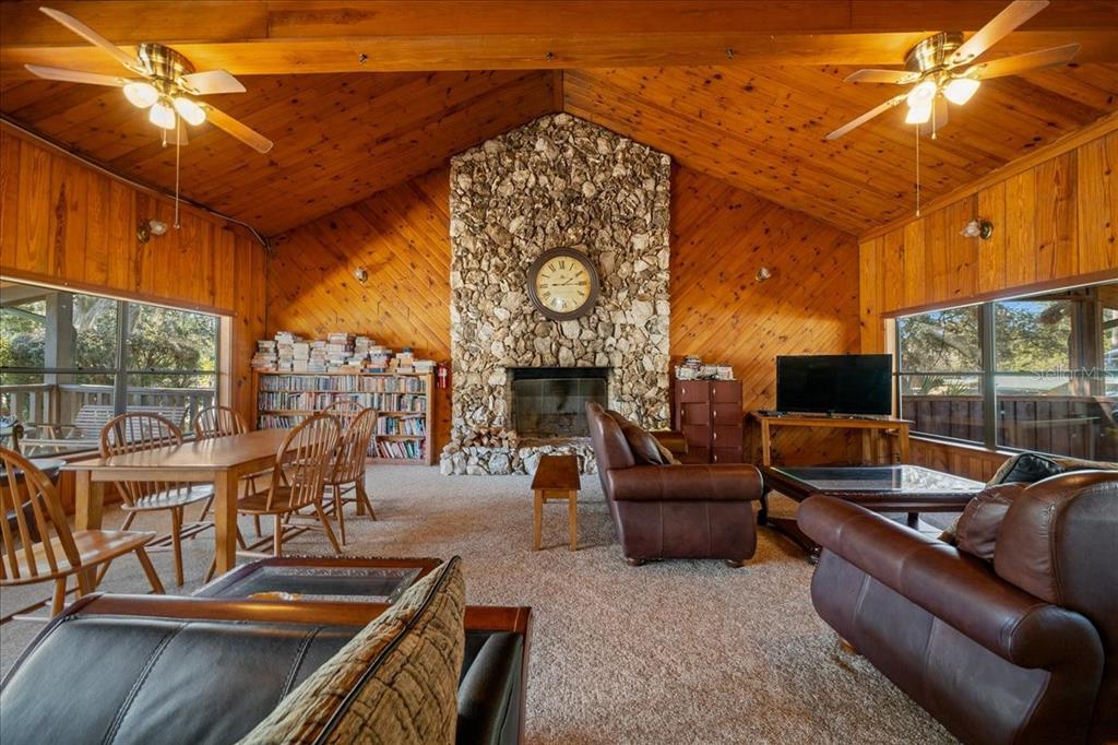 3047 Northeast 102nd Ave Road Silver Springs, FL 34488 - Photo 27 of 87 a outdoor living space with furniture and a fireplace