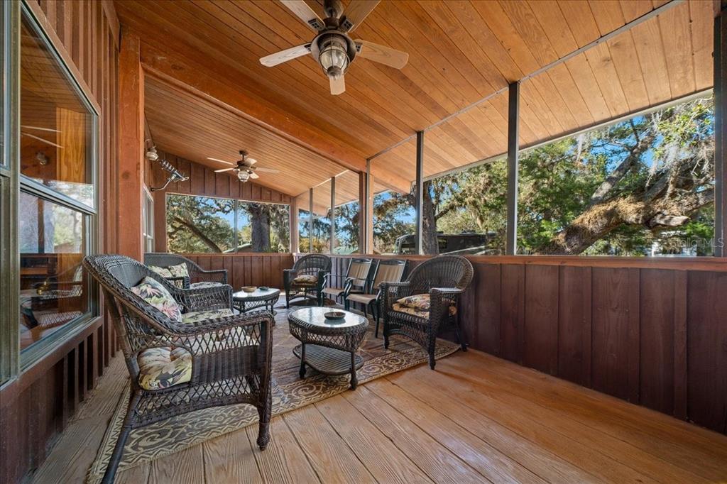 3047 Northeast 102nd Ave Road Silver Springs, FL 34488 - Photo 32 of 87 a view of a patio with table and chairs