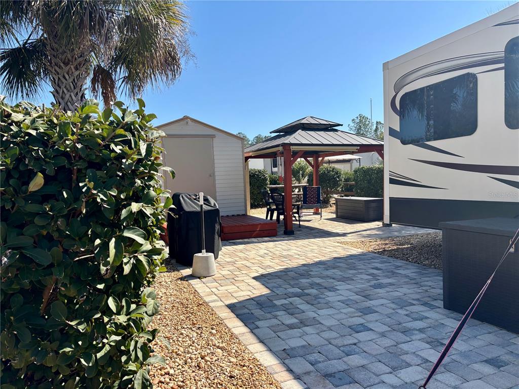 3047 Northeast 102nd Ave Road Silver Springs, FL 34488 - Photo 5 of 87 a view of a porch with chairs and potted plants