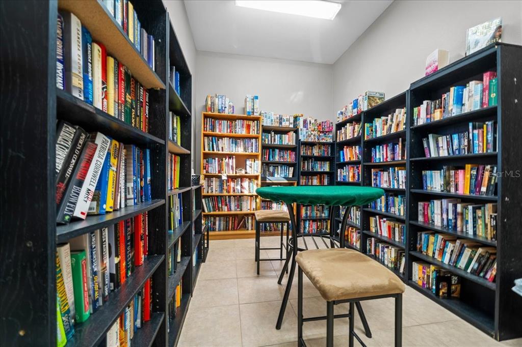3047 Northeast 102nd Ave Road Silver Springs, FL 34488 - Photo 82 of 87 a living room with lots of books