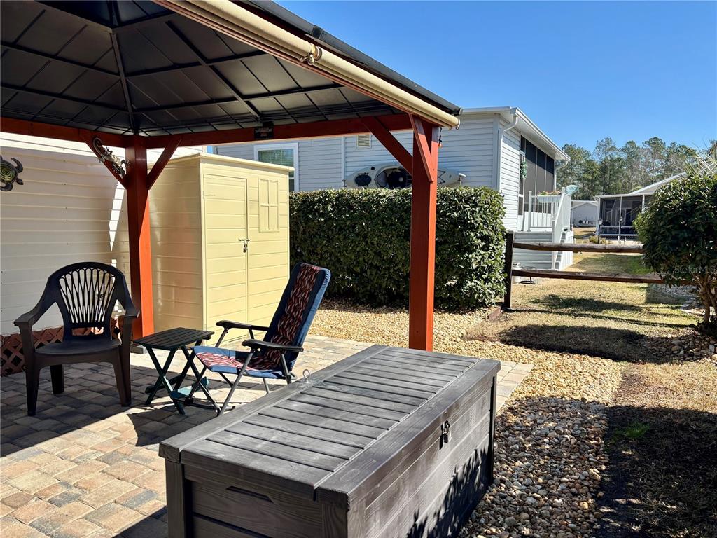 3047 Northeast 102nd Ave Road Silver Springs, FL 34488 - Photo 9 of 87 a view of a roof deck with table and chairs under an umbrella
