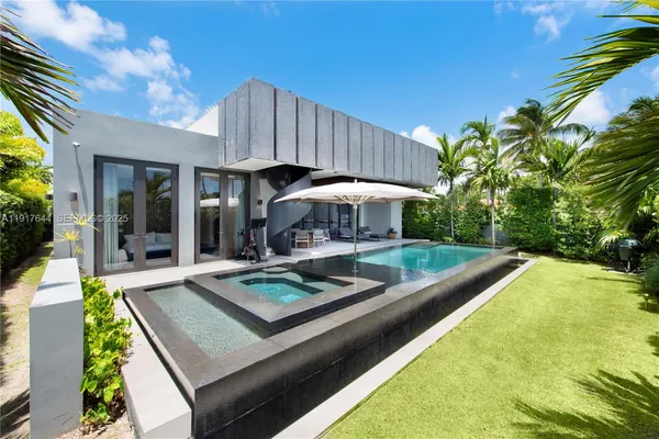 a view of a house with pool and chairs