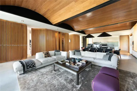 a living room with furniture rug and a large window