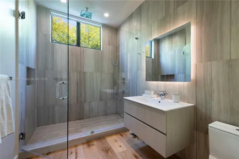 a bathroom with a sink a shower and a mirror