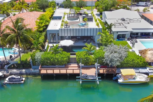 a view of a swimming pool with a patio and a garden