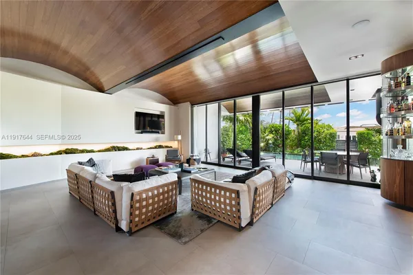 a bedroom with furniture and large windows