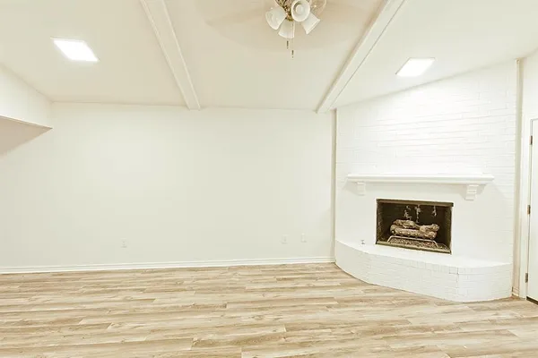 a view of an empty room with a fireplace