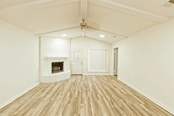 a view of empty room with a fireplace
