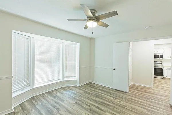 wooden floor in an empty room with a window