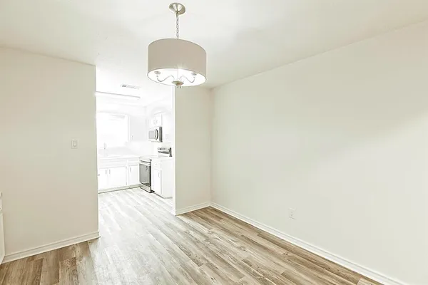a view of a room with a sink and wooden floor