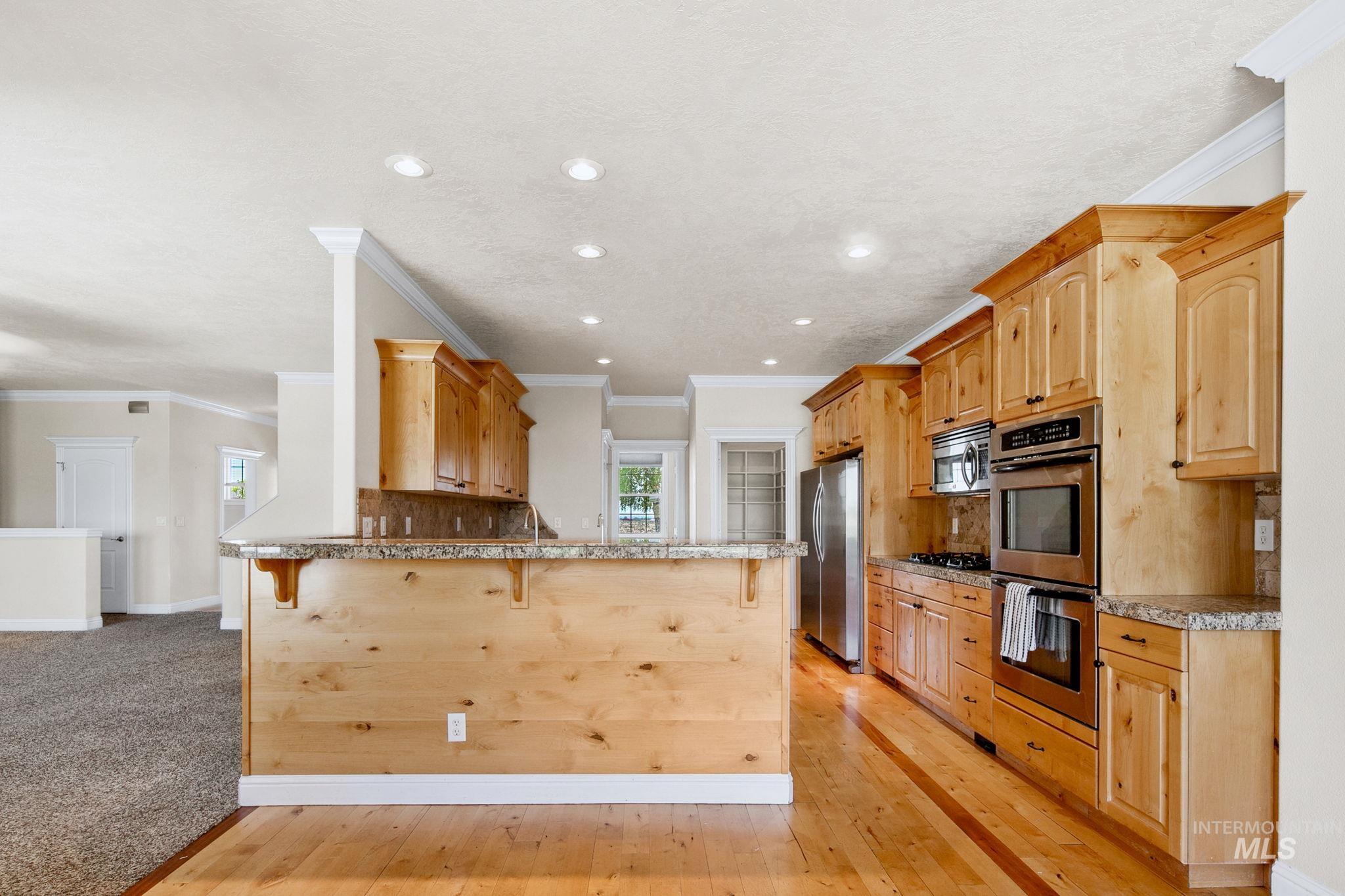 6850 Purple Sage Road Star, ID 83669 - Photo 35 of 50 Interior space featuring neutral wall tones, carpet flooring, a ceiling fan with integrated lighting, built-in shelving, and double French doors with blinds