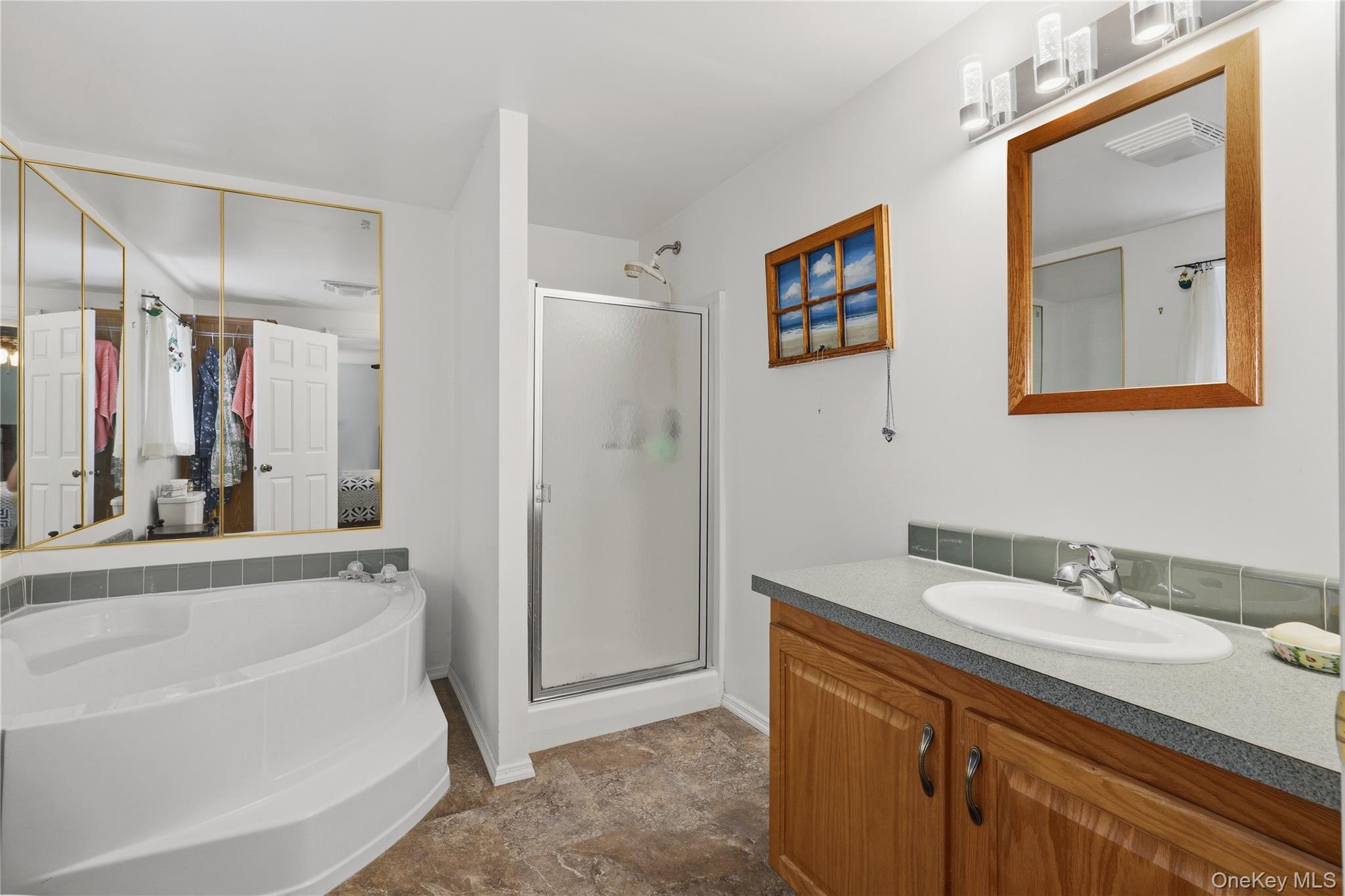 590 Farm To Market Road Brewster, NY 10509 - Photo 16 of 32 a bathroom with a tub a sink and mirror