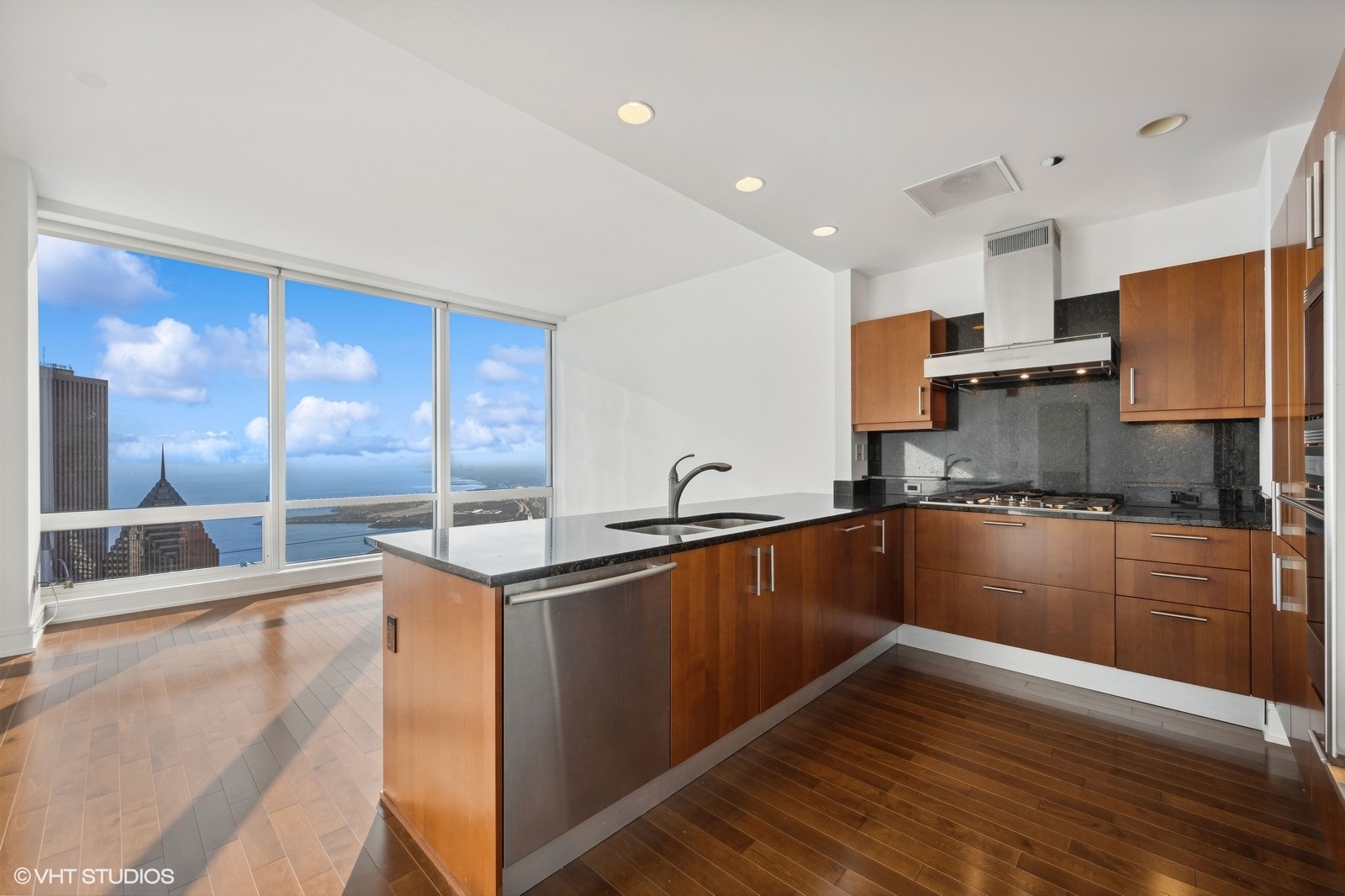 401 North Wabash Avenue, Unit 76E Chicago, IL 60611 - Photo 7 of 37 a kitchen with stainless steel appliances granite countertop a sink and cabinets