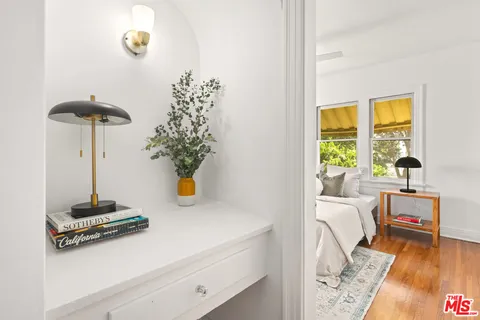a bedroom with a bed and wooden floor