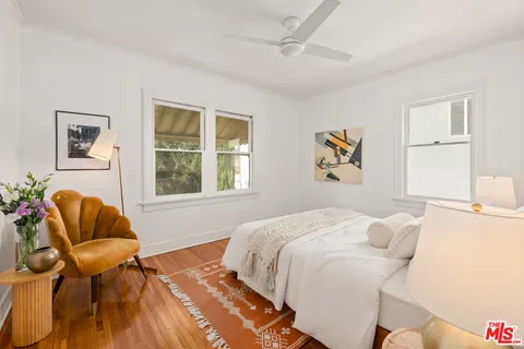 a bedroom with a bed and chair