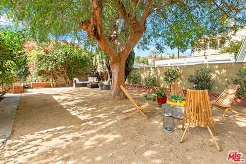 a view of a patio with table and chairs and potted plants