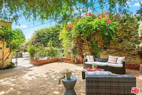 a view of a backyard with large trees