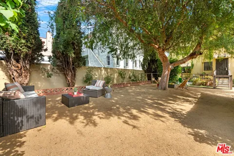 a view of a patio with table and chairs and potted plants