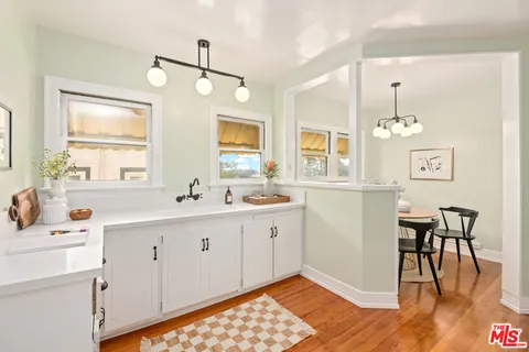 a spacious bathroom with a sink mirror and cabinets