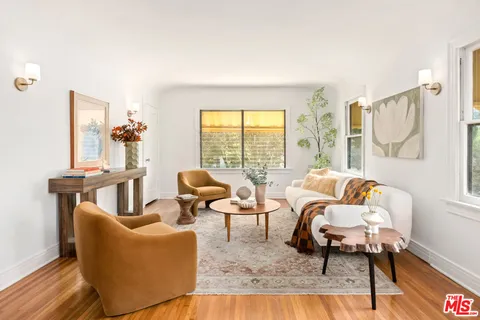 a living room with furniture and a floor to ceiling window
