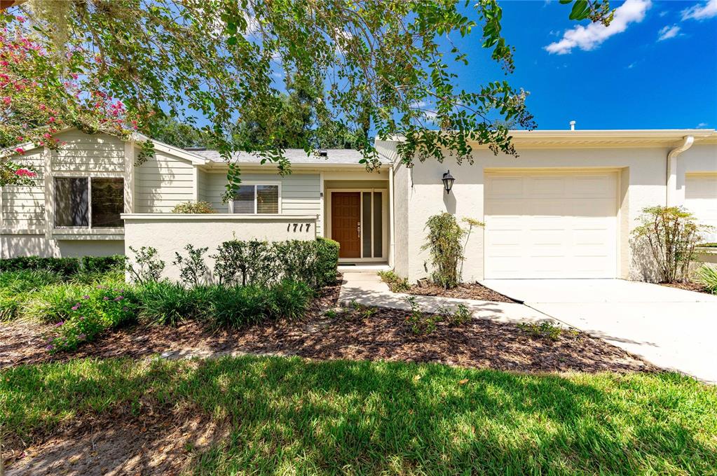 1717 Southeast 27th Loop Ocala, FL 34471 - Photo 1 of 1 a front view of a house with garden