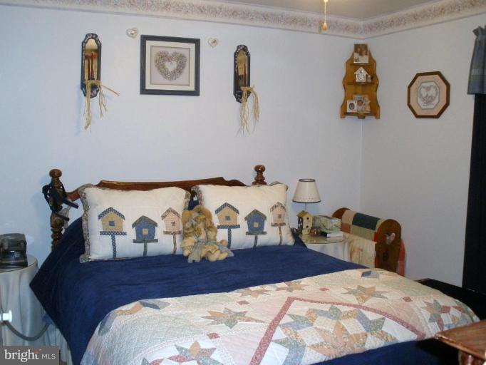 7002 Oliver Beach Road Middle River, MD 21220 - Photo 5 of 12 a bedroom with a bed and painting on the wall