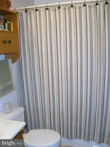 7002 Oliver Beach Road Middle River, MD 21220 - Photo 9 of 12 a bathroom with a toilet and a sink