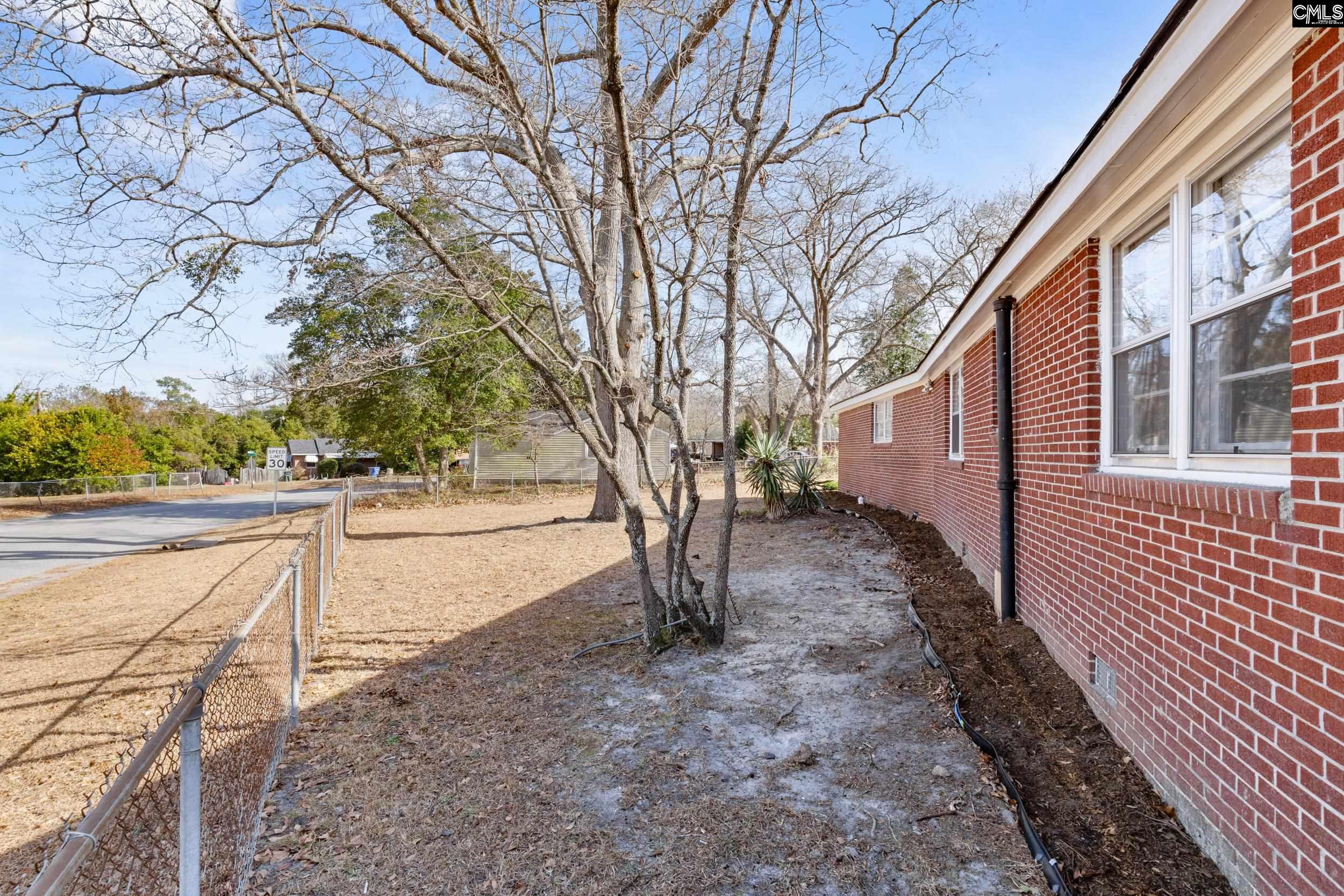 409 Wilkes Road Columbia, SC 29203 - Photo 32 of 34 a view of a yard with plants and trees