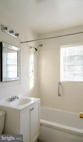 a bathroom with a sink a mirror and a bathtub